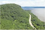  ?? CHELSEY LEWIS/MILWAUKEE JOURNAL SENTINEL ?? The Great River Road winds around Maiden Rock Bluff along Lake Pepin, a lake on the Mississipp­i River.