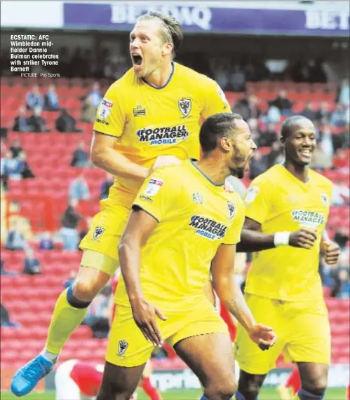  ?? PICTURE: Pro Sports ?? ECSTATIC: AFC Wimbledon midfielder Dannie Bulman celebrates with striker Tyrone Barnett