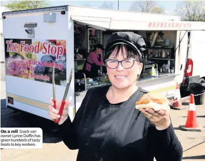  ??  ?? On a roll Snack van owner Lynne Duffin has given hundreds of tasty treats to key workers