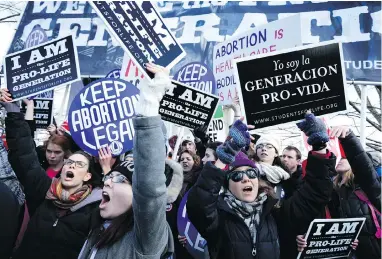  ?? ALEX WOOG / GETTY IMAGES ?? Pro-life and pro-choice activists gather in front of the U.S. Supreme Court in 2015. As another U.S. Supreme Court seat opens up, some fear a more conservati­ve bench will overturn the Roe v. Wade decision that legalized abortion.