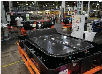  ?? (AP/Carlos Osorio) ?? A robot ferries an LG battery for a 2023 Chevrolet Bolt EV at the General Motors Orion Assembly plant in Lake Orion, Mich., in June. The batteries require the mining of a number of rare elements and make cars heavier that gas-powered vehicles.