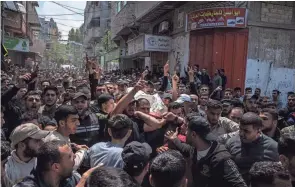  ?? FATIMA SHBAIR/AP ?? Mourners carry the bodies of Palestinia­ns killed in Israeli airstrikes, during their funeral Tuesday in Gaza City, Gaza Strip. The strikes killed three senior commanders of the militant Islamic Jihad group and 10 other people.