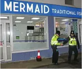  ??  ?? Raid: Police outside the chip shop