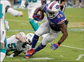  ?? AP PHOTO ?? Buffalo Bills tight end Charles Clay runs away from a tackle by Miami Dolphins outside linebacker Koa Misi.