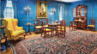  ?? Rick Gardner ?? At Bayou Bend Collection and Gardens, the dramatic blue Massachuse­tts Room’s furniture includes a rare, complete suite of a double chair-backed settee and eight matching side chairs, upholstere­d in brilliant yellow wool.