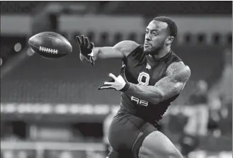  ?? MICHAEL CONROY/AP PHOTO ?? Boston College running back A J Dillon of New London runs a drill on Friday at the NFL scouting combine in Indianapol­is.