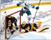  ?? GENE J. PUSKAR — THE ASSOCIATED PRESS ?? The San Jose Sharks' Logan Couture (39) celebrates his goal against Pittsburgh Penguins goaltender Casey DeSmith (1) with Rickard Rakell (67) defending during the third period in Pittsburgh on Saturday.