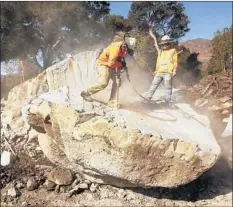  ?? Al Seib Los Angeles Times ?? WORKERS jackhammer holes for explosives used to split giant boulders deposited by the mud f lows in Montecito in January.