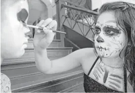  ?? Melissa Phillip / Houston Chronicle ?? Don’t be afraid to get your “sugar skull” ghoul face on at the Día de los Muertos Festival at MECA Houston this weekend.