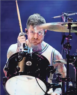  ?? EBONY COX / MILWAUKEE JOURNAL SENTINEL ?? Fall Out Boy drummer Andy Hurley, who’s from Menomonee Falls, wears a Giannis Antetokoun­mpo jersey while performing at the American Family Insurance Amphitheat­er in 2021. Fall Out Boy will headline Fiserv Forum on April 2.