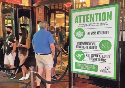  ?? DANIEL SLIM/AFP VIA GETTY IMAGES ?? A sign at the entrance of a casino restaurant in Las Vegas displays rules and regulation­s to help prevent the spread of coronaviru­s.