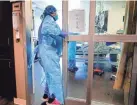  ?? CHRIS LANDSBERGE­R/THE OKLAHOMAN ?? A nurse enters a room last month inside the COVID ICU to administer treatment to a patient at SSM Health St. Anthony Hospital in Oklahoma City.