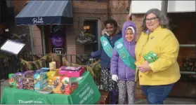  ?? LAUREN HALLIGAN - MEDIANEWS GROUP ?? Assemblywo­man Carrie Woerner smiles with two representa­tives from Girl Scout Troop #3031 at their cookie booth on Saturday morning on Broadway in Saratoga Springs.