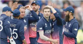  ?? — Reuters ?? England’s Mark Wood celebrates the wicket of Australia’s Glenn Maxwell.