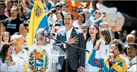  ?? ARIANA CUBILLOS/AP ?? Opposition leader Juan Guaido sings the national anthem Tuesday in Caracas.