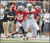  ?? Associated Press ?? Ohio State defensive back Cameron Brown (26) knocks the ball away from Oregon receiver Devon Williams (2), an AV High grad, during the first half on Saturday in Columbus, Ohio. Oregon won 35-28.