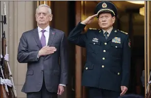  ?? AP/PABLO MARTINEZ MONSIVAIS ?? Defense Secretary James Mattis and Chinese Defense Minister Wei Fenghe stand Friday as their countries’ national anthems are played at a welcoming ceremony at the Pentagon before their talks.