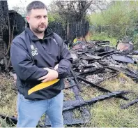  ??  ?? Gareth Cross with the garage destroyed in a ‘suspicious’ fire