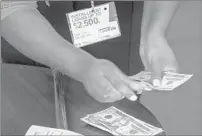  ?? SID HASTINGS/AP 2018 ?? A manager of a financial services store makes a loan in Ballwin, Mo. Consumer protection­s are being rolled back.