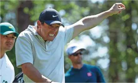  ?? ASSOCIATED PRESS ?? Rory McIlroy reacts to a shot by Adam Scott on the fourth hole Friday at Augusta National.