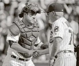  ?? Jon Durr / Getty Images ?? Manager Joe Maddon, right, decided that Miguel Montero had to be purged.