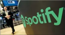  ?? RICHARD DREW — THE ASSOCIATED PRESS ?? A trading post sports the Spotify logo on the floor of the New York Stock Exchange on Tuesday.