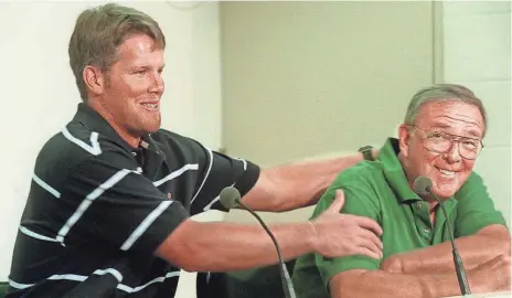  ?? PLUS FILES ?? Brett Favre playfully grabs general manager Ron Wolf during a news conference on July 25, 1997 in which the quarterbac­k’s new seven-year contract was announced..PACKER