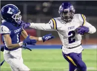  ?? Jim Franco / Special to the Times Union ?? Troy running back Xavier Leigh stiff-arms La Salle defender Nassir Young during opening day of football season at La Salle Institute. Leigh finished with 184 yards rushing on 23 carries and scored two TDS on Friday night.