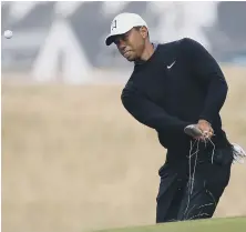  ??  ?? Tiger Woods plays a shot on the fifth hole at Carnoustie yesterday.