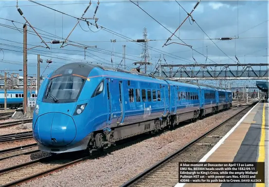  ?? DAVID ALCOCK ?? A blue moment at Doncaster on April 13 as Lumo EMU No. 803004 heads south with the 1E82/09.11 Edinburgh to King’s Cross, while the empty Midland Pullman HST set – with power cars Nos. 43055 and 43046 – waits for its path back to Crewe.