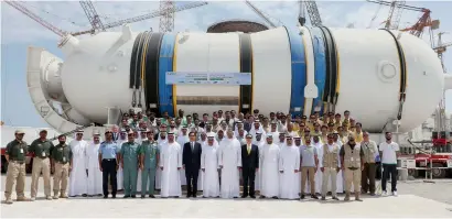  ?? Supplied photos ?? Enec officials and staff in front of the newly installed steam generator at the Barakah Nuclear Energy Plant’s Unit 4. —