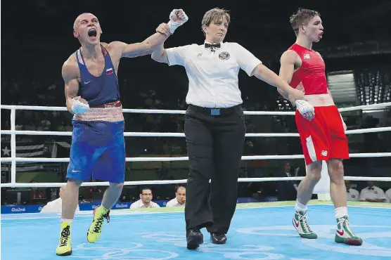  ?? CHRISTIAN PETERSEN/GETTY IMAGES ?? Russia’s Vladimir Nikitin, left, celebrates his victory over Michael John Conlan of Ireland in men’s bantam boxing at Riocentro on Tuesday.