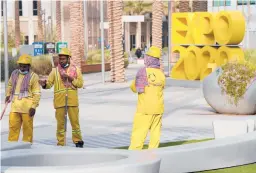  ?? JON GAMBRELL/AP ?? Cleaners seen in October at Expo 2020 in the United Arab Emirates.