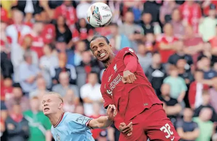  ?? | AFP NIGEL RODDIS ?? MANCHESTER City striker Erling Haaland (L) fights for the ball with Liverpool defender Joel Matip during the English FA Community Shield earlier in the season. The two teams clash in a league game tomorrow.