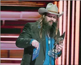 ?? CHRIS PIZZELLO/INVISION/AP ?? Chris Stapleton accepts the award for album of the year for “From A Room: Volume 1” at the 51st annual CMA Awards on Nov. 8.