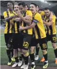  ??  ?? Party time: AEK Athens scorer Rodrigo Galo (centre) celebrates with team-mates