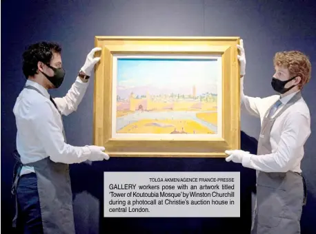  ?? TOLGA AKMEN/AGENCE FRANCE-PRESSE ?? GALLERY workers pose with an artwork titled ‘Tower of Koutoubia Mosque’ by Winston Churchill during a photocall at Christie’s auction house in central London.