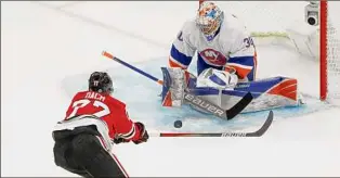  ?? Charles Rex Arbogast / Associated Press ?? Islanders goaltender Ilya Sorokin denies the Blackhawks' Kirby Dach during the second period on Tuesday night in Chicago. Sorokin finished with 39 saves.