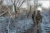  ?? BRENDAN HOFFMAN — THE NEW YORK TIMES ?? Ukrainian soldiers patrol last month in Avdiivka, a city near the border with Russia. Moscow has amassed tens of thousands of troops along the border.