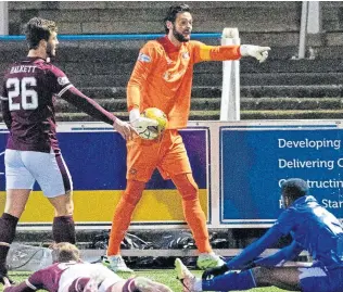  ??  ?? Craig Gordon protests as Queen of the South are awarded a penalty