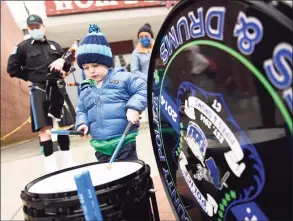 ??  ?? Stamford’s William Fitzsimmon­s, 2, plays the drums before the Fairfield County Police Pipes and Drums concert.