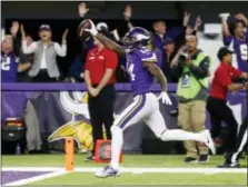  ?? JIM MONE — THE ASSOCIATED PRESS ?? Minnesota Vikings wide receiver Stefon Diggs (14) runs in for a game-winning touchdown against the New Orleans Saints Sunday in Minneapoli­s. The Vikings defeated the Saints 29-24.