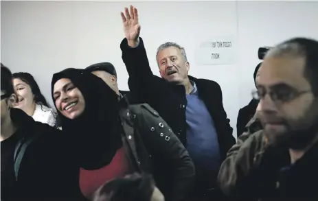  ?? AFP ?? Bassem Tamimi, centre, the father of Ahed Tamimi, 17, the well-known teenage campaigner against Israel’s occupation, waves as she arrives from prison for her trial at the Israeli military court yesterday at Ofer military base in the West Bank