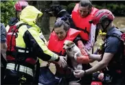  ?? BUTCH DILL — THE ASSOCIATED PRESS ?? Residents of an apartment complex are rescued as severe weather produced torrential rainfall, flooding several apartment buildings Tuesday in Homewood, Ala. Thousands in Southern states lost power.