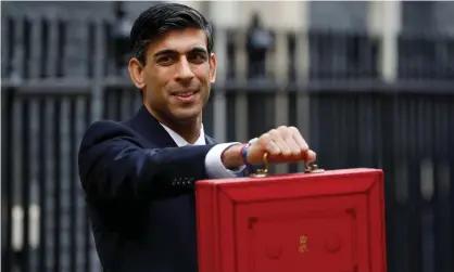  ?? Photograph: PeterNicho­lls/Reuters ?? The chancellor, Rishi Sunak, holds the budget box outside 11 Downing Street.