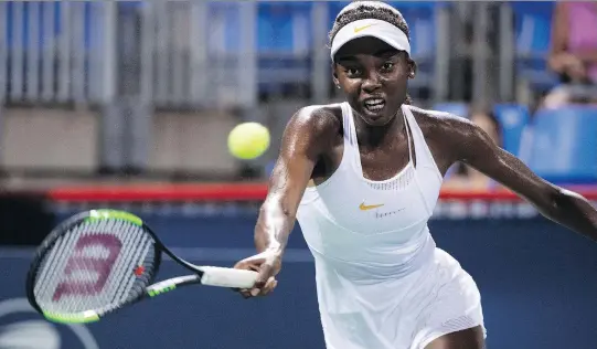  ?? PHOTOS: PAUL CHIASSON/THE CANADIAN PRESS ?? Françoise Abanda knocked off world No. 47 Kirsten Flipkens of Belgium Tuesday during first-round play at the Rogers Cup.
