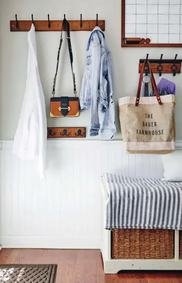  ??  ?? |TOP LEFT| ORGANIZING OUTERWEAR. The backdoor entry is a stylish landing zone where everything can be styled and updated for the season. “All those pieces on the wall are interchang­eable. The throw on top is striped now, but throughout the seasons I change that. You don’t have to worry about cushions; you can just swap out blankets on top. For winter, I’ll do a plaid or a checked throw.”