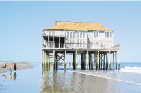  ?? PHOTO COURTESY OF C. HOBBS/VIMS ?? $250,000 and a match will go to help bolster rapidly eroding Cedar Island on the Eastern Shore, left, by building up its marsh. Rapid landward migration has stranded several vacation homes built there in the 1980s.$2.2 million, along with matching funds, will be used to build adaptive living shorelines and green infrastruc­ture projects in Hampton.$1.3 million, and a $1.2 million match, will build a hybrid living shoreline and expand a riparian buffer along the Lafayette River