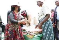  ?? ?? Agric4She patron First Lady Dr Auxillia Mnangagwa hands over farming inputs to women in Zhombe yesterday