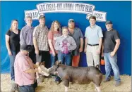  ?? SUBMITTED PHOTO ?? Brihnlee Hunt with Farmington FFA stands in front of the backdrop with her Champion Berkshire Market Hog at the Arkansas Oklahoma State Fair in Fort Smith.
